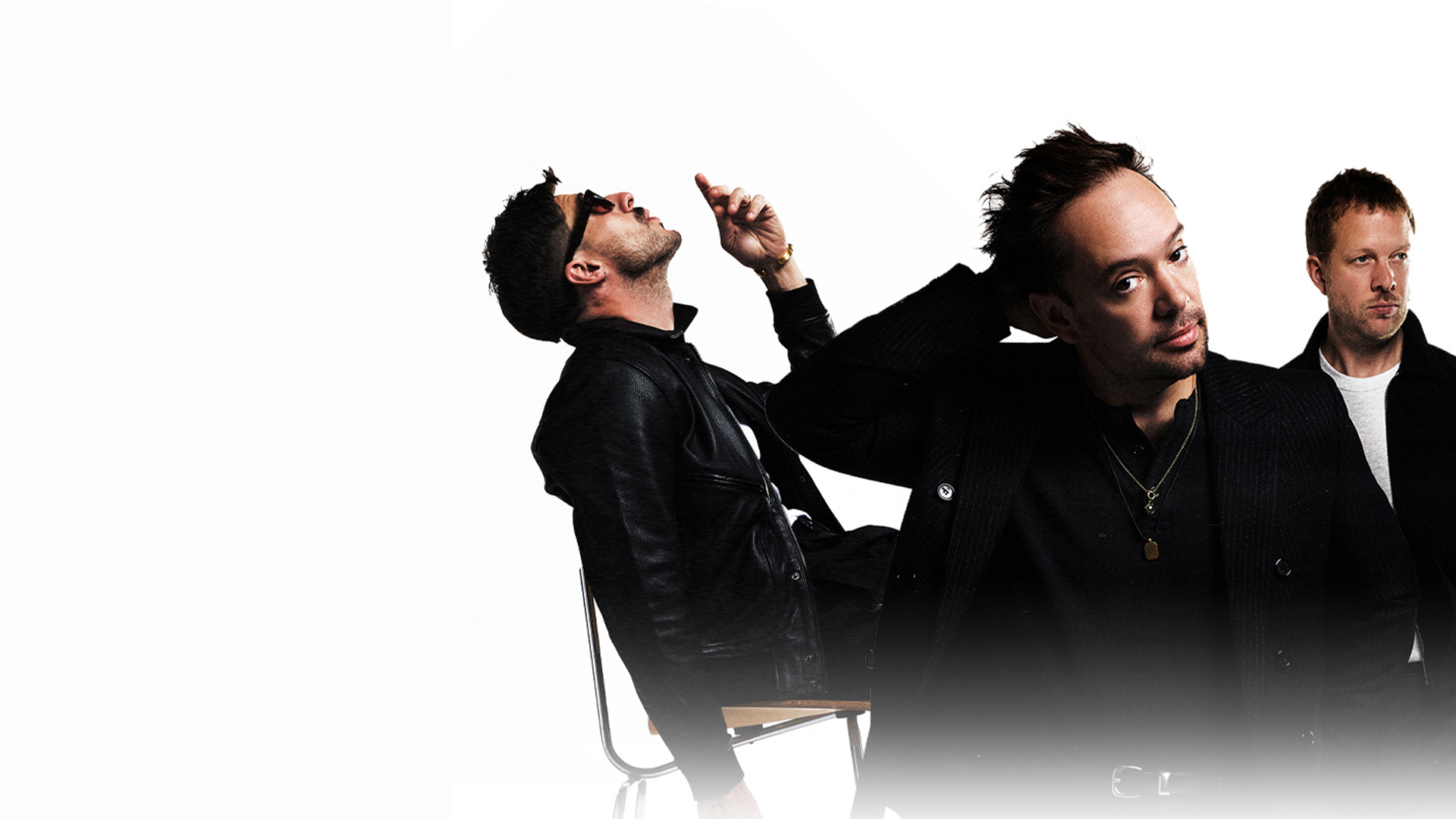 Mumford & Sons band members posing for the camera against a white background.