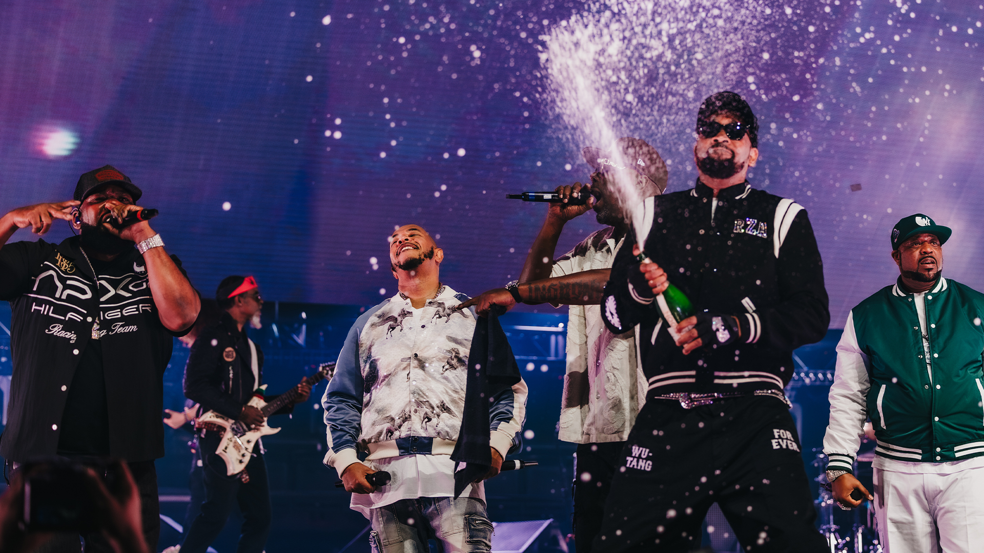 Wu-Tang Clan band members performing on stage.