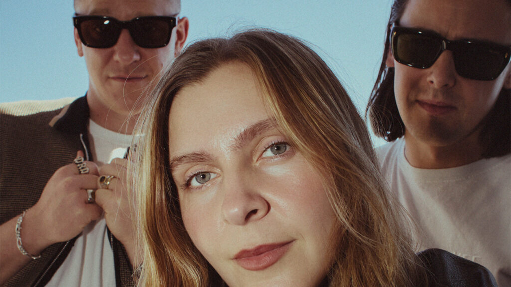 Jungle band members pose together in an outdoor setting.