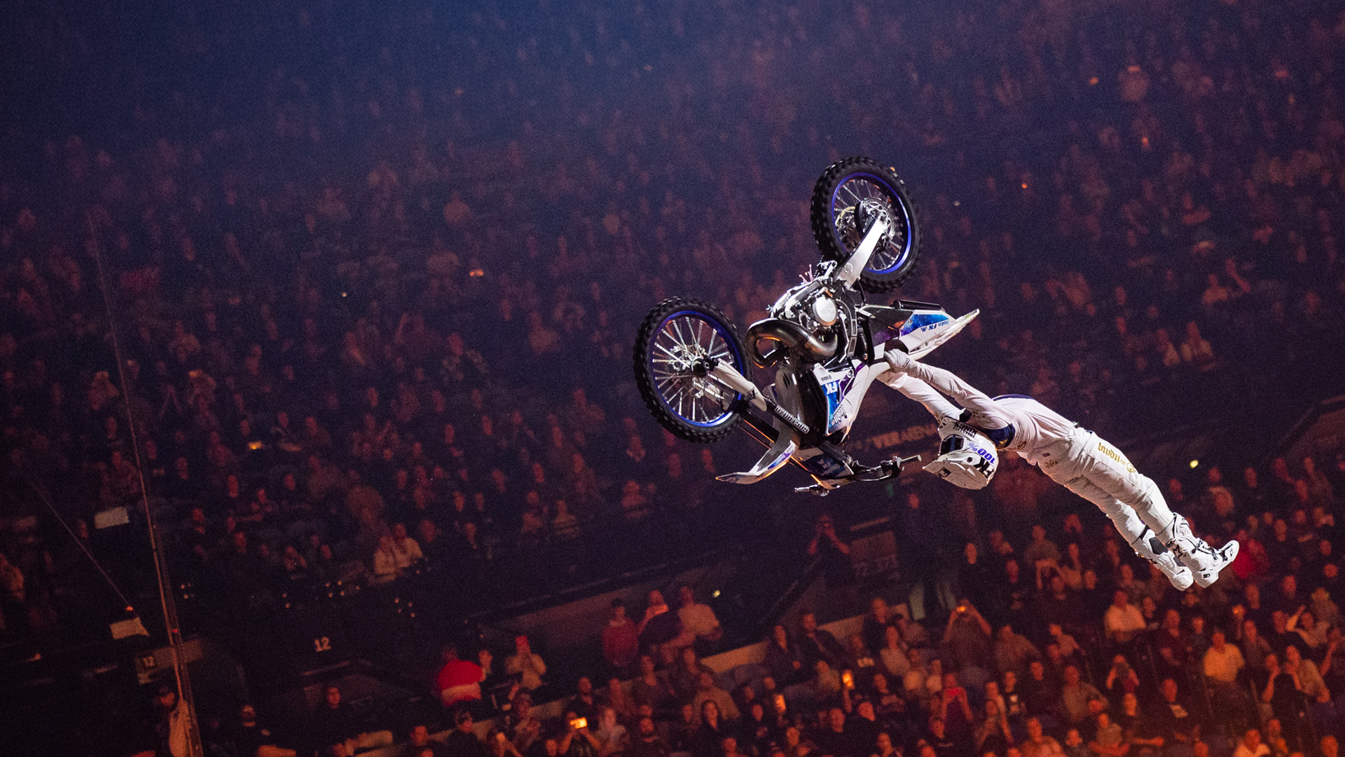 A motorcyclist executes a mid-air trick.