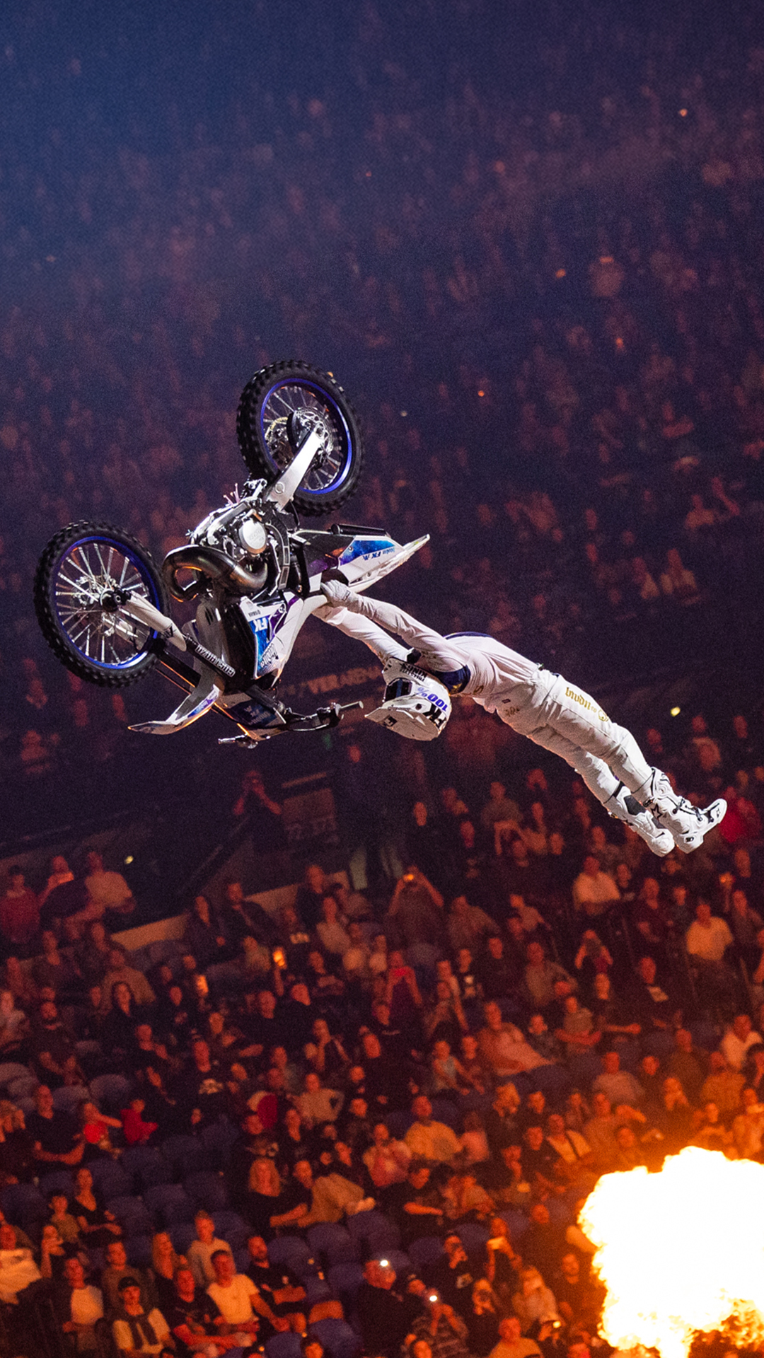 A motorcyclist executes a mid-air trick.