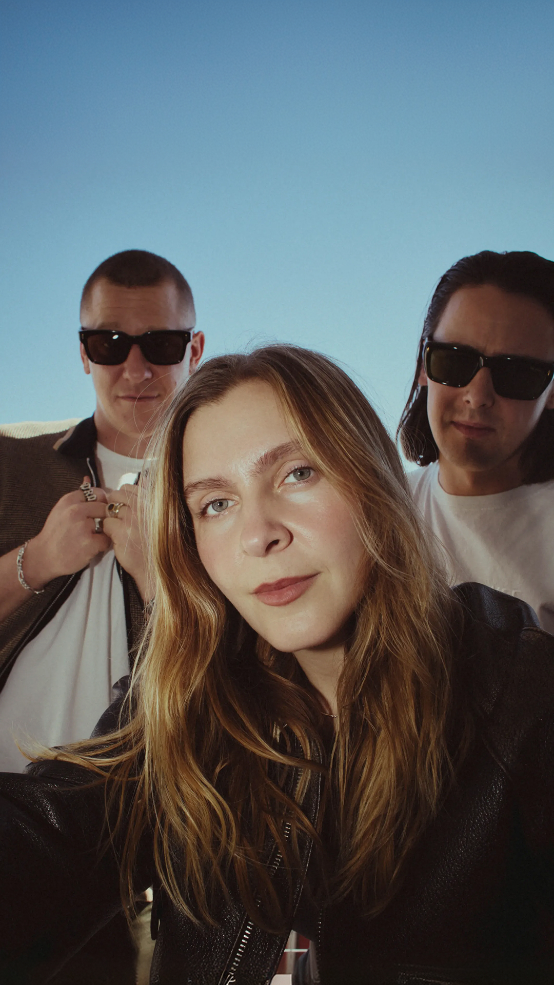 Jungle band members pose together in an outdoor setting.