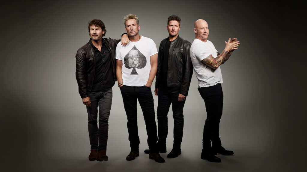 Band members of Nickleback pose against a grey background.